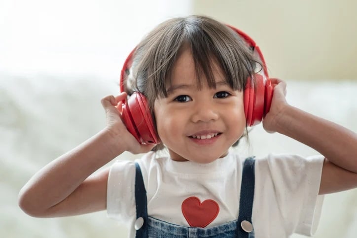 photograph of girl with noise cancelling headphones